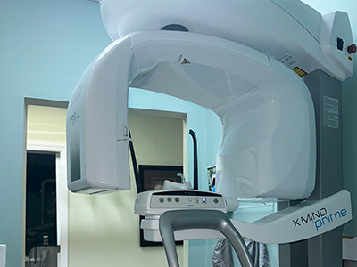 A modern medical imaging machine in a room, with the word  MIND  visible on it.